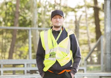 Photo of Richard wearing a yellow high viz waistcoat at work